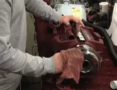 Vacuum repair technician cleaning and servicing a vacuum motor in Orange, CA