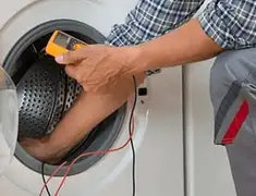 Washing machine repair technician testing a front-load washer with diagnostic tools in Orange, CA